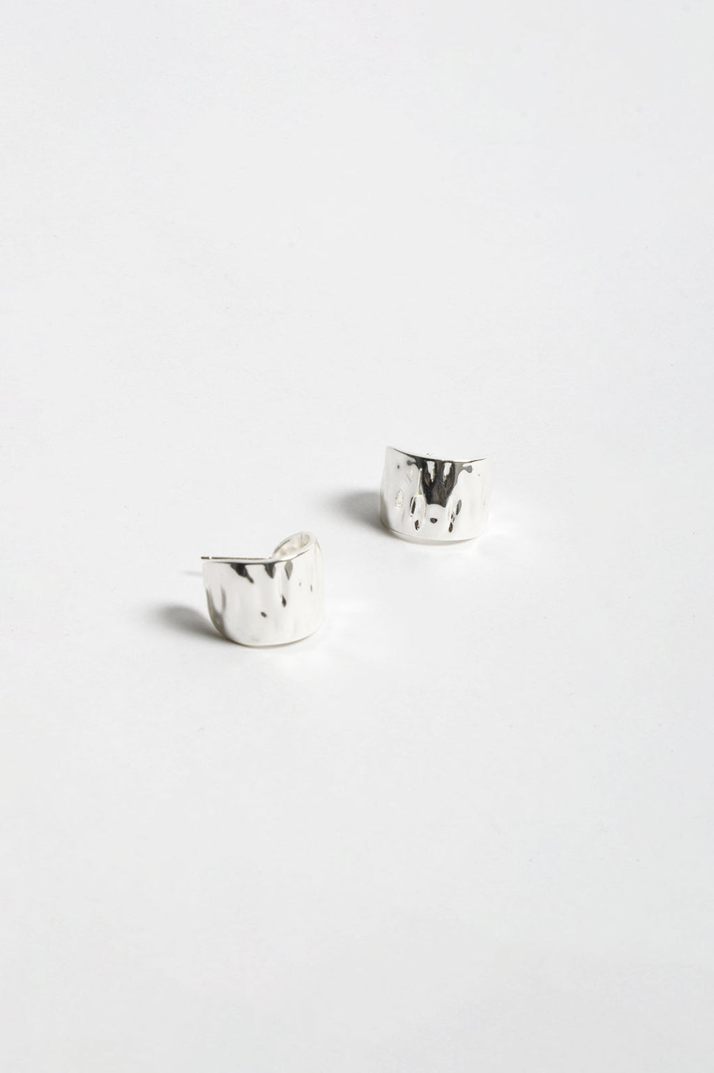 Mini Textured Curved Hoop Earrings in silver – front view, mini hammered finish curved hoops | Sonella