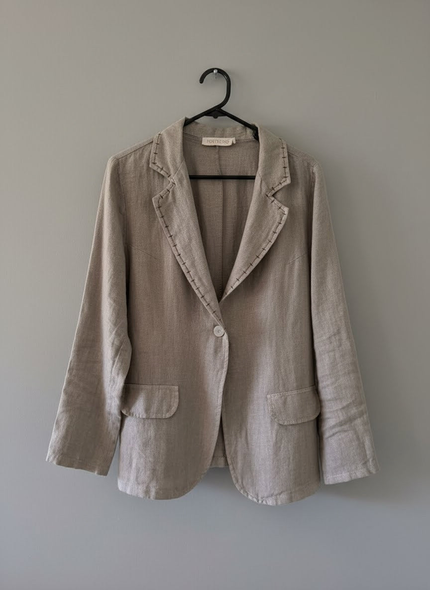 Elora Linen Blazer in fango – flat lay on hanger showing single button fastening, decorative stitching along lapels, rounded front panels and flap pockets | Sonella