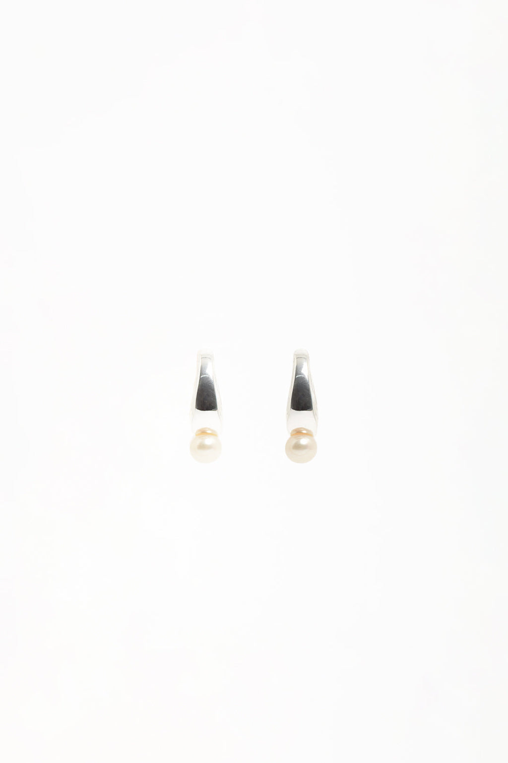 Pearl Drop Curved Front Half Hoop Earrings in silver with cream pearl – styled view showing curved half hoop silhouette | Sonella