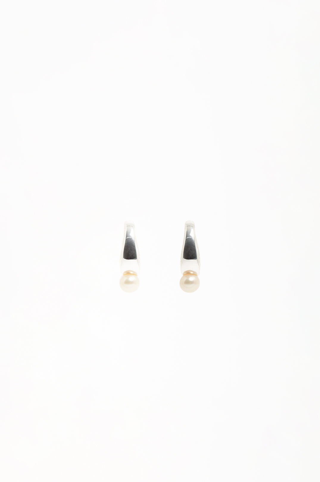 Pearl Drop Curved Front Half Hoop Earrings in silver with cream pearl – styled view showing curved half hoop silhouette | Sonella